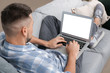 © Pixel-Shot - Handsome man with laptop at home