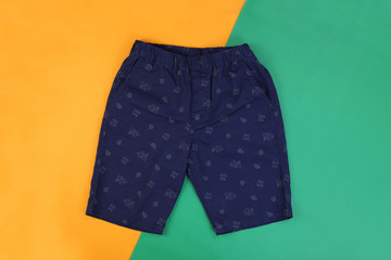 Sticker - Navy blue casual short pants on orange and green pastel background