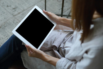 Business woman using tablet on wooden desk