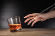 Alcoholism concept . Hands lock chain a glass of whiskey To stop drinking . Stop alcohol addiction . Addicting to alcoholic drink.