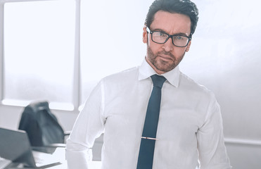 Wall Mural - confident businessman standing in a spacious office