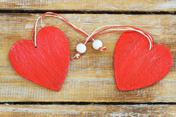 Wall Mural - two red wooden hearts on rustic wooden surface with copy space