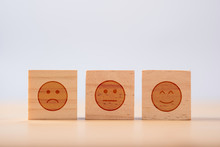 Smiley Emotion To Among Normal And Sad Emotion Which Print Screen On Wooden Cubic. Customer Experience Survey And Satisfaction Feedback Concept.