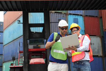 Engineering group working and they are loading container for support logistics and import export business