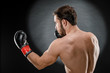 © fusssergei - A man in Boxing gloves. A man Boxing on a black background. The concept of a healthy lifestyle
