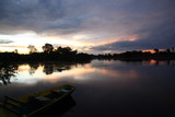 Fototapeta Pomosty - Landscape of Amazon jungle river with floating boat during sunrise  in Brazil