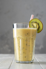 Wall Mural - Protein shake with kiwi on white wooden boards. Fresh milkshake with kiwi. Smoothies.