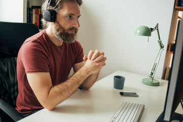 Wall Mural - Male freelancer working from his home desk