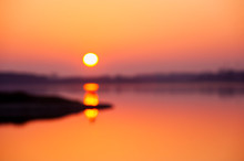 Out Of Focus Picture Of The Sunset Over The Lake