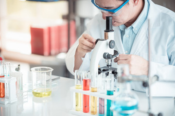 Scientist looking through microscope in laboratory with copy space using as background science, medical , education, biology, chemistry concept.