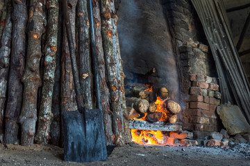 Wall Mural - traditional charcoal kiln with charcoal under production with mangrove (Rhizophora sp) wood