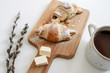 © dmitry_dmg - Homemade puff on wooden plate, cup of hot chocolate and sprig of willow