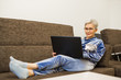 © Alexandr - stylish stylish woman with short haircut with laptop at home