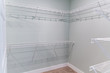 Empty master bedroom walk-in closet with wire shelving