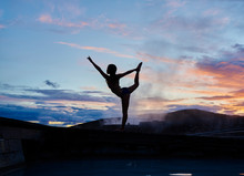Silhouette Of A Young Woman Doing Yoga In The Mountain By Hot Spring Thermal Bath At Sunset 