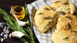 Selective focus. Fresh homemade focaccia with rosemary and sea salt. Italian traditional bread. Flat bread. Cooking at home.