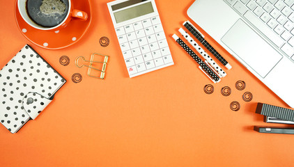 Canvas Print - Desktop workspace flat lay with hi-tech touch screen laptop and modern orange, black and white accessories on orange trend background. Negative copy space.