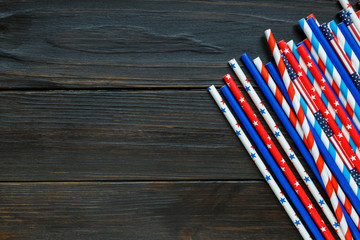 Wall Mural - Decorations for 4th of July day of American independence, flag, candles, straws. USA holiday decorations on a wooden background, top view, flat lay