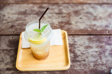 Lemon lime ice drink in plastic bottle on wood table