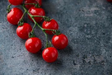 Wall Mural - Fresh cherry tomatoes on dark background.