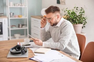 Sticker - Young man with tablet computer working at home