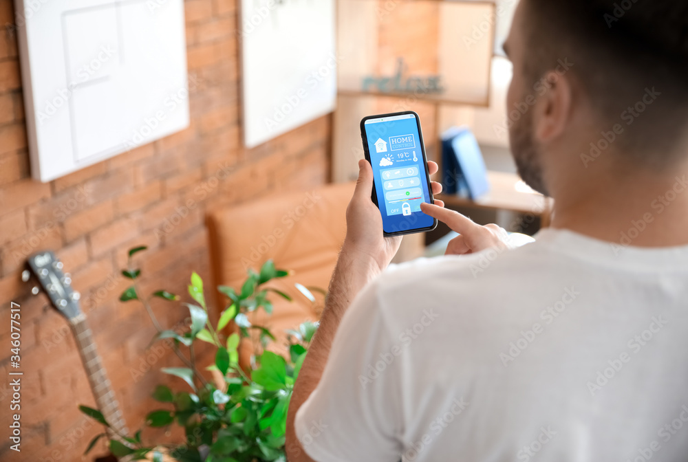 Man using application of smart home automation