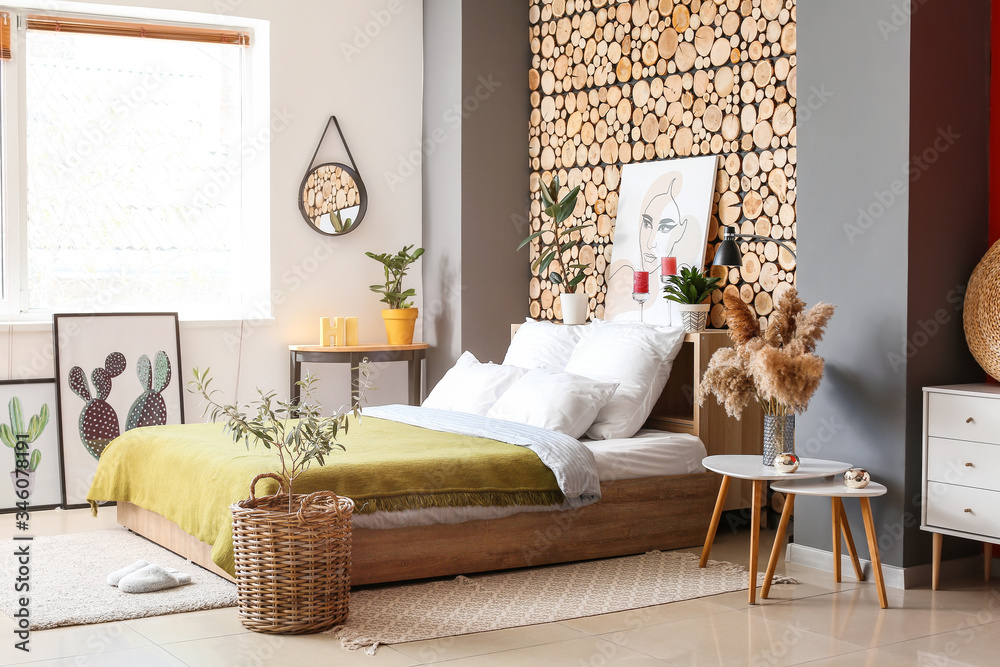 Stylish interior of bedroom with houseplants