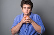 © Eugene - Sleepy man in a bathrobe drinks morning coffee or tea.