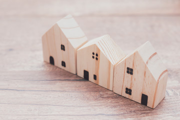 Wall Mural - Model house on wooden background.investment insurance and home purchase mortgage concept