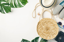 Straw Hat, Camera, Bag, Summer Shoes, Sunglasses, Shells And Tropical Leaves Over White Background, Top View.