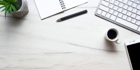 white desk office with laptop, smartphone and other work supplies with cup of coffee. top view with 