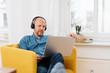 © contrastwerkstatt - Man wearing headphones working on a laptop