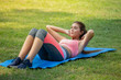 © iammotos - Beautiful  fitness young woman in sportswear doing sit ups on mat in park . sport Fit girl push up exercise in morning . healthy lifestyle concept.  workout . training. endurance . smile