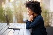 © mimagephotos - Side of young african american business woman sitting with laptop computer