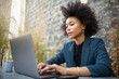 © mimagephotos - Close up businesswoman sitting with laptop computer at table