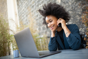 Wall Mural - Close up smiling business woman working with laptop computer and cellphone