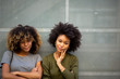 © mimagephotos - two cool young black woman with afro hair