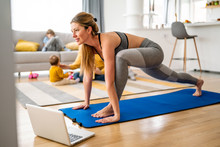 Young Woman Is Exercising Yoga At Home. Fitness, Workout, Healthy Living And Diet Concept.
