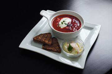 Wall Mural - Delicious ukrainian borsh on plate with bread.