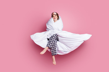 Poster - Full length photo of cheerful funny lady satisfied morning sitting bed hug warm blanket wear mask white plaid pajama pants barefoot isolated pink color background