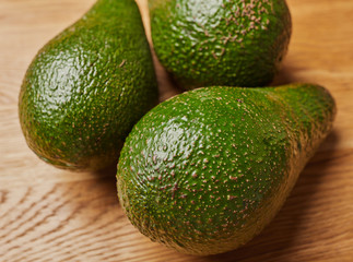 green avocado on a wooden table