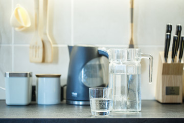 Wall Mural - Glass of pure water on kitchen table.