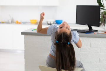 Pretty stylish schoolgirl studying homework math during her online lesson at home, social distance during quarantine, self-isolation, online education concept, home schooler