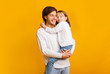 © Prostock-studio - Positive father and daughter posing together on yellow background
