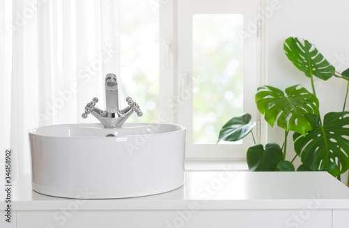 Cuadros en Lienzo Hygienic wash basin with chrome faucet on bathroom window background