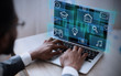© Prostock-studio - African American businessman working on his laptop in office, selecting functional icon from virtual interface, collage