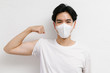 © Gengwit - Young asian healthy male wearing medical face mask to protect corona virus, studio portrait.