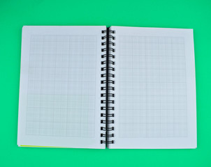 Wall Mural - Top view of an open white spiral paper notebook placed on top of a paper background