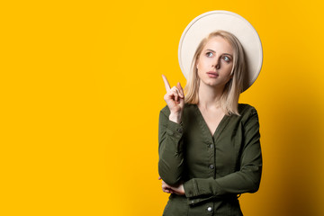 Sticker - Blonde woman in hat and green shirt on yellow background