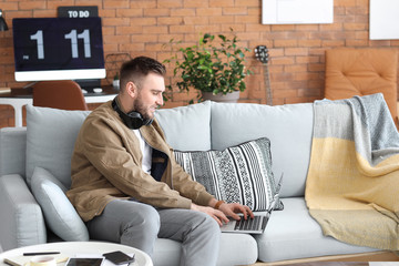 Canvas Print - Young man with laptop working at home